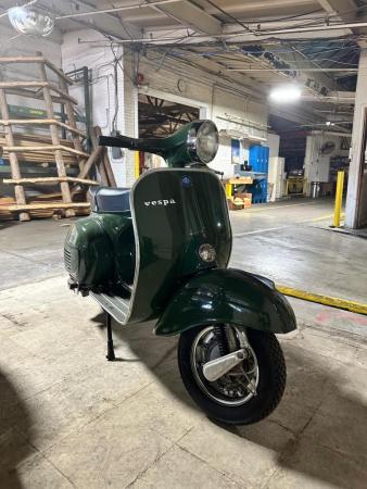 This is a pictorial representation of a 1977 vespa t.s (jungla verde)