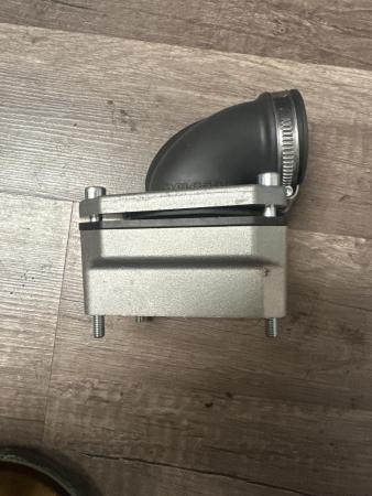 This is a photograph of a vespa reed valve intake