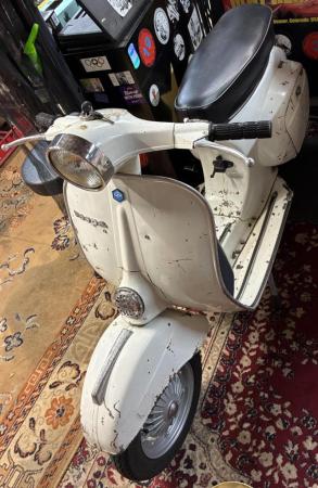 This is a depiction of a 1978 vespa 50 special w/ 135cc malossi kit